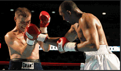 Two boxers exchanging punches in the ring during a professional bout